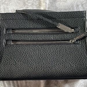 Been used once! Lots of pockets and very soft leather